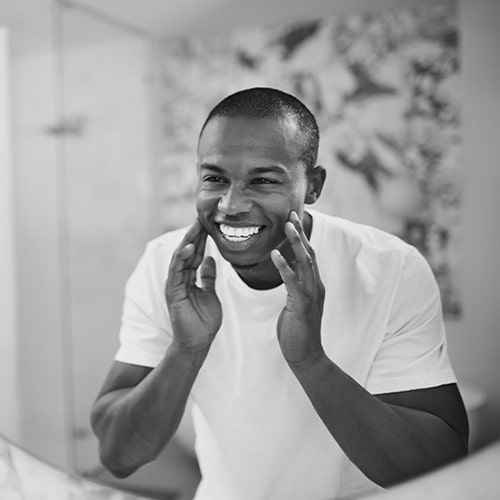 A young man smiling in the mirror